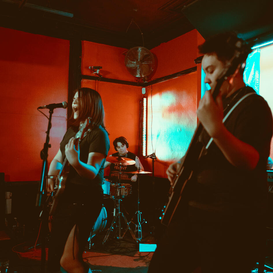 Yuppie Supper performing on a red stage.